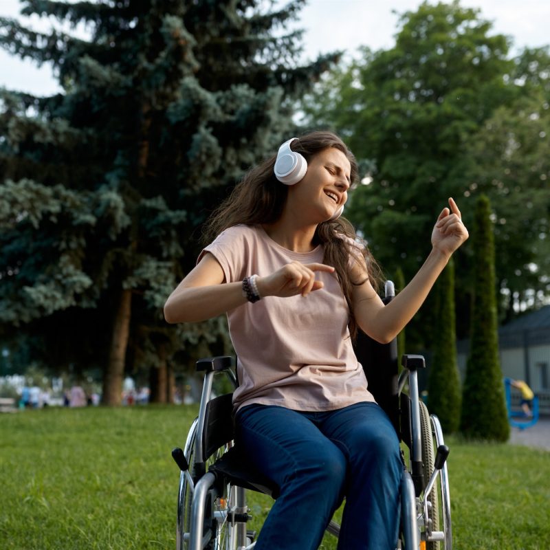 disabled-woman-in-wheelchair-listens-to-music